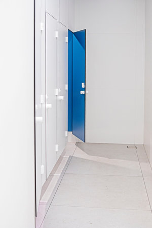 blue doors to the toilet room in a light interior in a supermarket