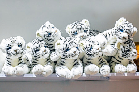 cute fluffy soft toy white tigers on the shelfの写真素材