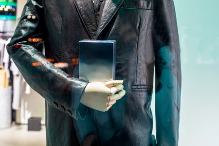 mannequin in a leather coat holding a bookの写真素材