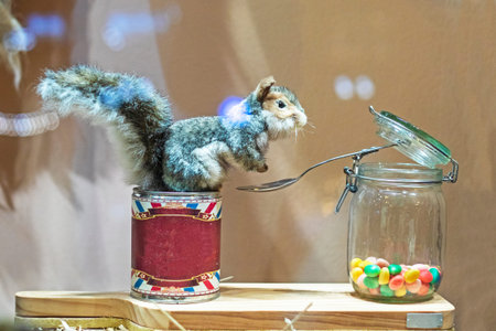 interactive fur squirrel eats lollipops from a spoon