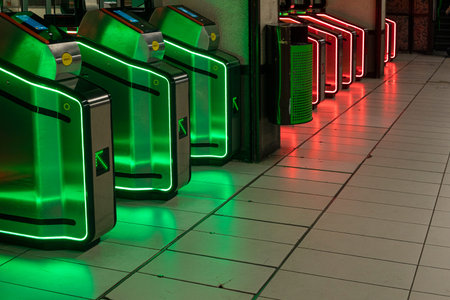 modern turnstiles with red prohibitory and green permitting colors in the metro in Italy