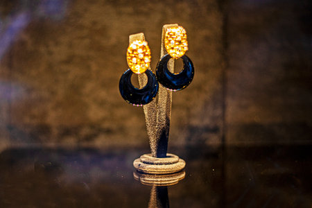 semi-circular earrings with enamel on a dark backgroundの写真素材