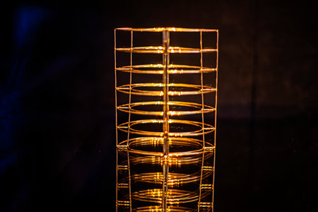 abstract golden cylindrical shape on a dark backgroundの写真素材