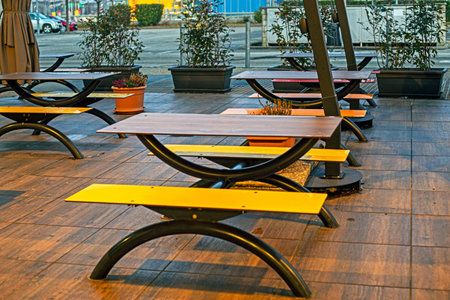 designer stylish wooden tables in an outdoor cafe