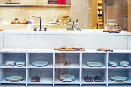 light stylish interior in the kitchen with white modular shelves and dishesの写真素材