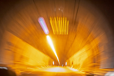 illuminated autotunnel at night on a toll roadの写真素材