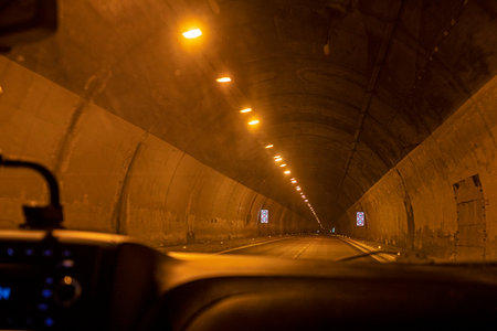 illuminated autotunnel at night on a toll roadの写真素材