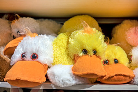 cute fluffy toy ducklings on a shelfの写真素材
