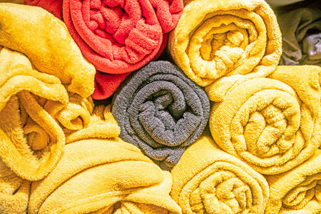 plush stylish blanket rolled up close up in the interiorの写真素材