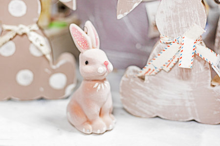 cute easter bunny on light brown background with other craft bunnies. Easter holidayの写真素材