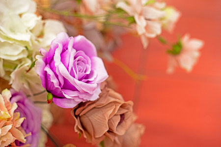 delicate bouquet of white, cream roses, purple roses and other flowers