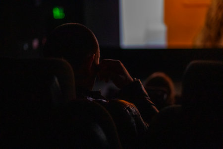 watching a movie with the whole family at the cinema. family day outの写真素材