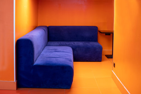 orange stylish interior with blue upholstered furniture in the waiting room