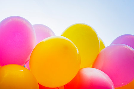 multi-colored inflatable balloons against the background of the blue sky. Holidayの写真素材