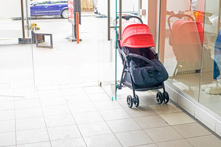 baby stroller near the entrance to the storeの写真素材