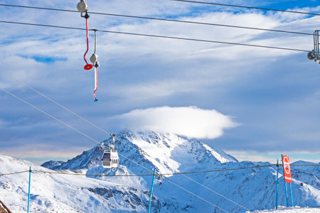 view of evening mountain peaks and ski lifts in the alpsの写真素材