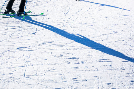snowy ski slope with ski and snowboard marks in the alps. Active recreationの写真素材