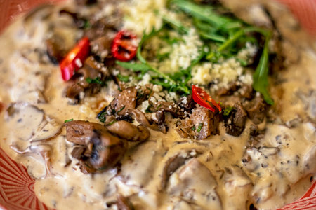 porcini mushrooms in a creamy sauce with pepper and arugula. Vegetable proteinの写真素材