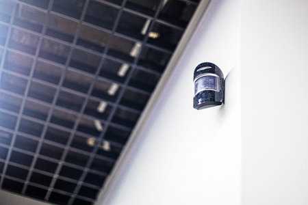 wall mount surveillance camera in stylish technical office and home. Safety and reliability