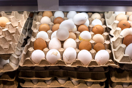 chicken white and brown eggs in a cardboard container in the supermarket.