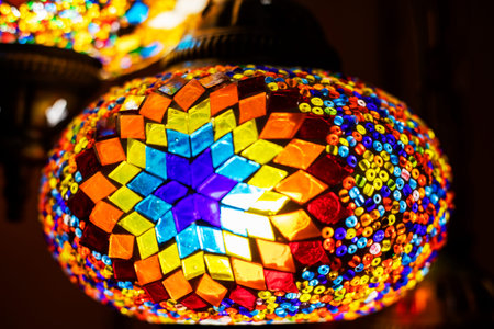 stained glass lamp on a dark background with a geometric pattern in red shades