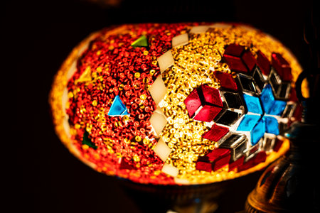 stained glass lamp on a dark background with a geometric pattern in red shadesの写真素材