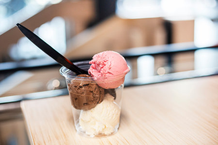 three scoops of ice cream strawberry vanilla and chocolateの写真素材