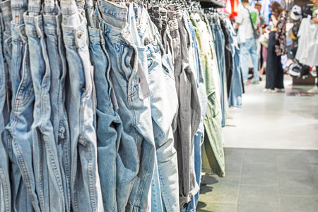 stylish women's and men's jeans in the supermarket in the clothing departmentの写真素材