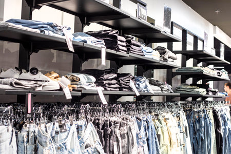 stylish women's and men's jeans in the supermarket in the clothing departmentの写真素材