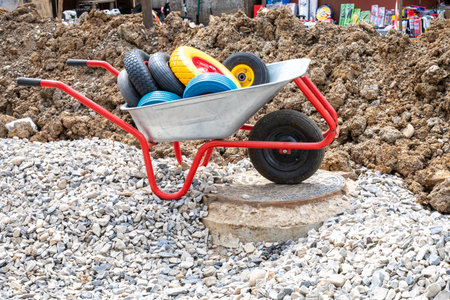 wheelbarrow with wheels near the dug up surface outside