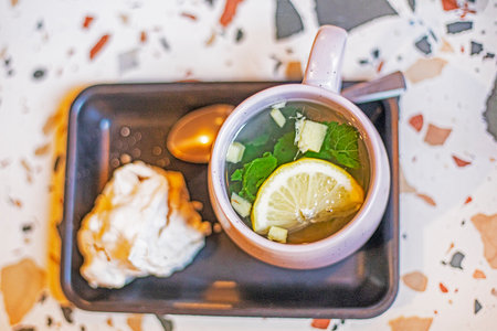 ginger tea with lemon and mint and with nut meringue. good morningの写真素材