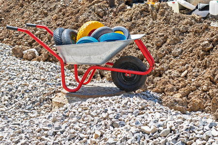 construction cart with wheels on the background of dug earth and rubble