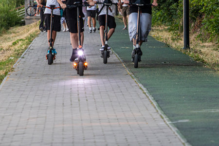 teenagers racing on electric scooters on a sports trackの写真素材