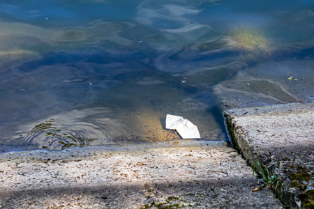 paper boat of wishes in the water near the rocky shore. Esotericsの写真素材