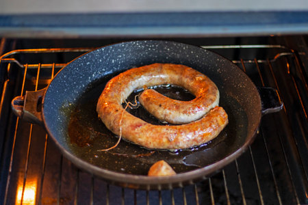 homemade sausage baked in a frying pan with different types of meat. Preparation for the holidayの写真素材