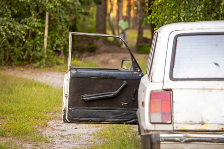 open door of an old car in the forest. weekend dayの写真素材