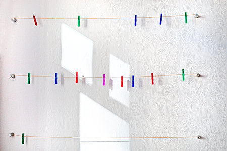 classroom with hanging colorful clothespins on ropes on a light wall. Back to schoolの写真素材