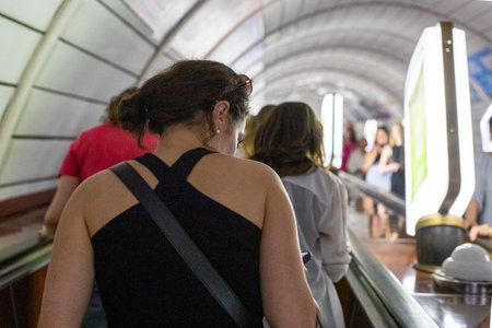crowd of people during rush hour is about to leave the subway escalatorの写真素材