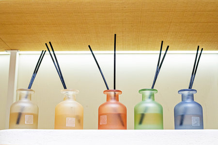 various fragrances for freshening rooms in multi-colored glass jars with sticks
