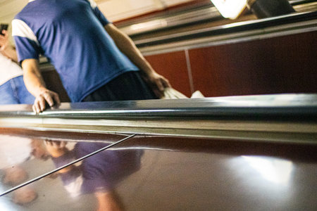 going down the escalator in the metro and holding on to the handrails