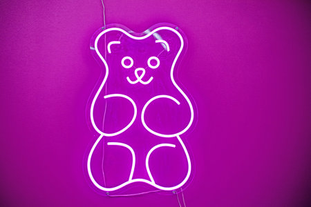 cute silhouette of a bear with single light bulbs on a pink background