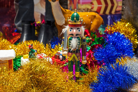 wooden figurine of a nutcracker among holiday decorations