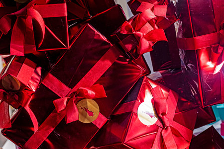 packaging red gifts tied with gold ribbon Christmas, festive background. Boxing Dayの写真素材