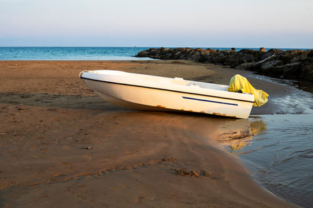 boat on the beach near the water in the evening. Traveling around Italyの写真素材