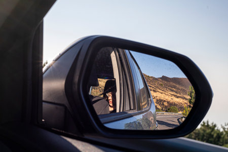 road to Etna volcano through the right mirror of the car. car tripの写真素材