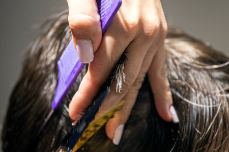stylist creates a trendy haircut by removing the ends of the hair from the topの写真素材