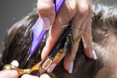 stylist creates a stylish men's haircut with a comb