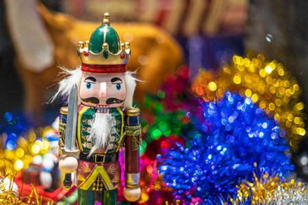 Nutcracker figurine on Afon confit and Christmas paper garlands Stylish gifts under the Christmas...