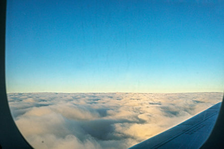 view of clouds and sky from an airplane window. Travel. Business trip.