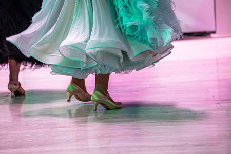 Young ladies in delicate, fluffy dresses dance a standard program on the floorの写真素材